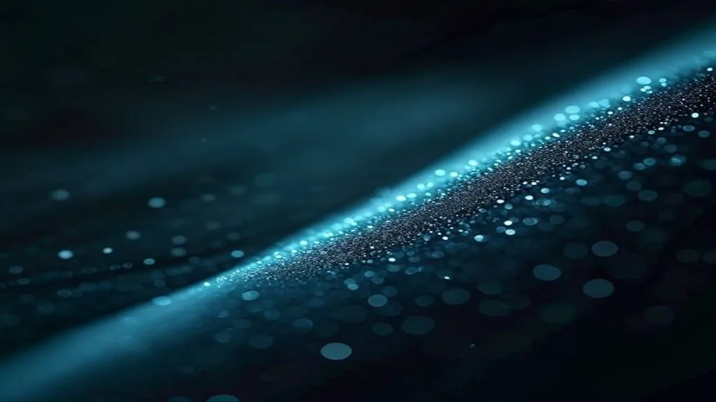 A single arc of small luminous points along a smooth curve on a matte dark surface